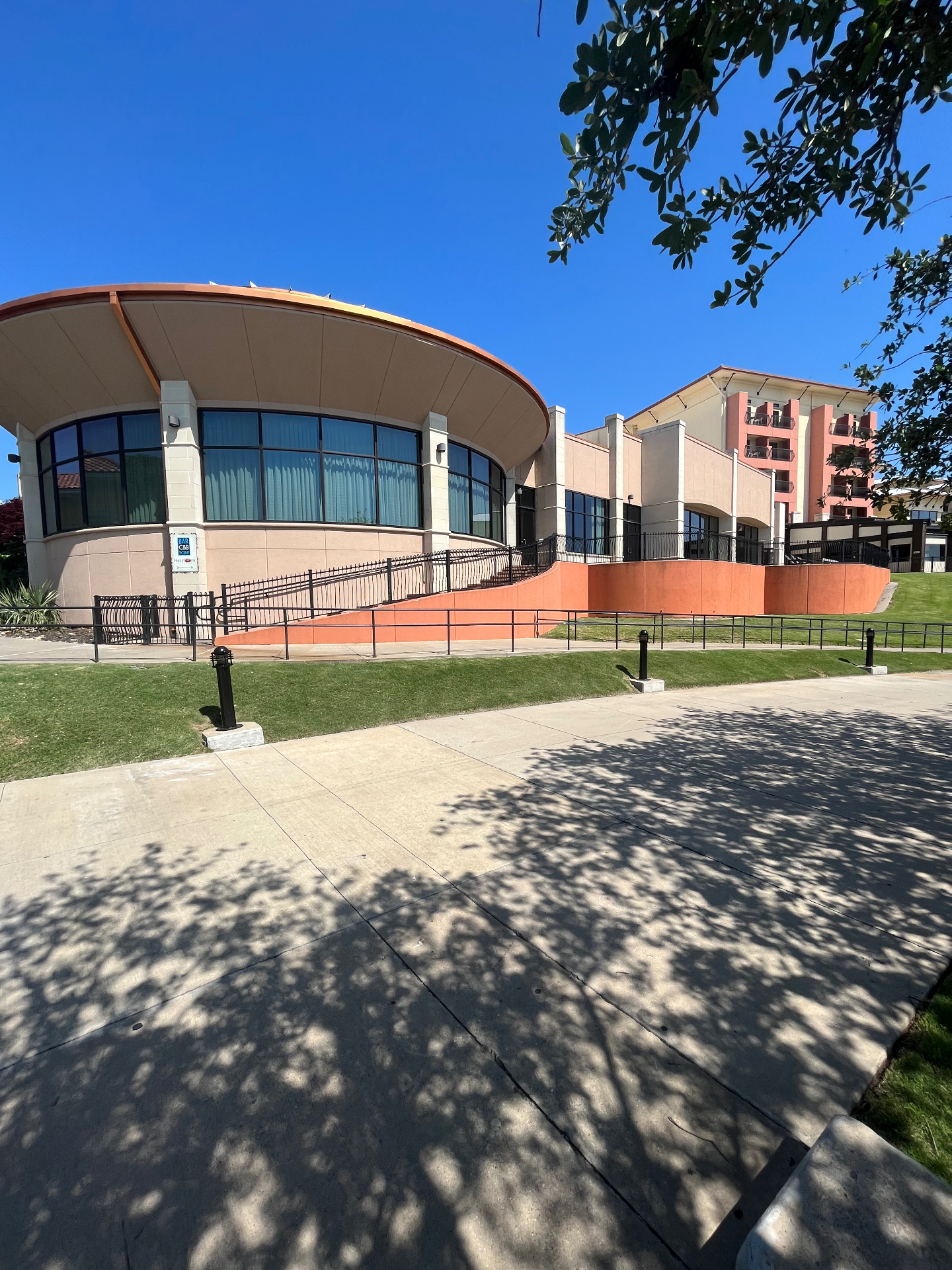 Commercial building featuring curved glass windows with tint
