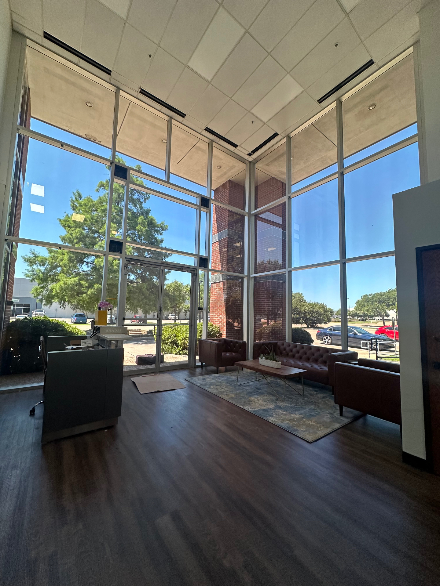 Commercial lobby with floor-to-ceiling tinted windows