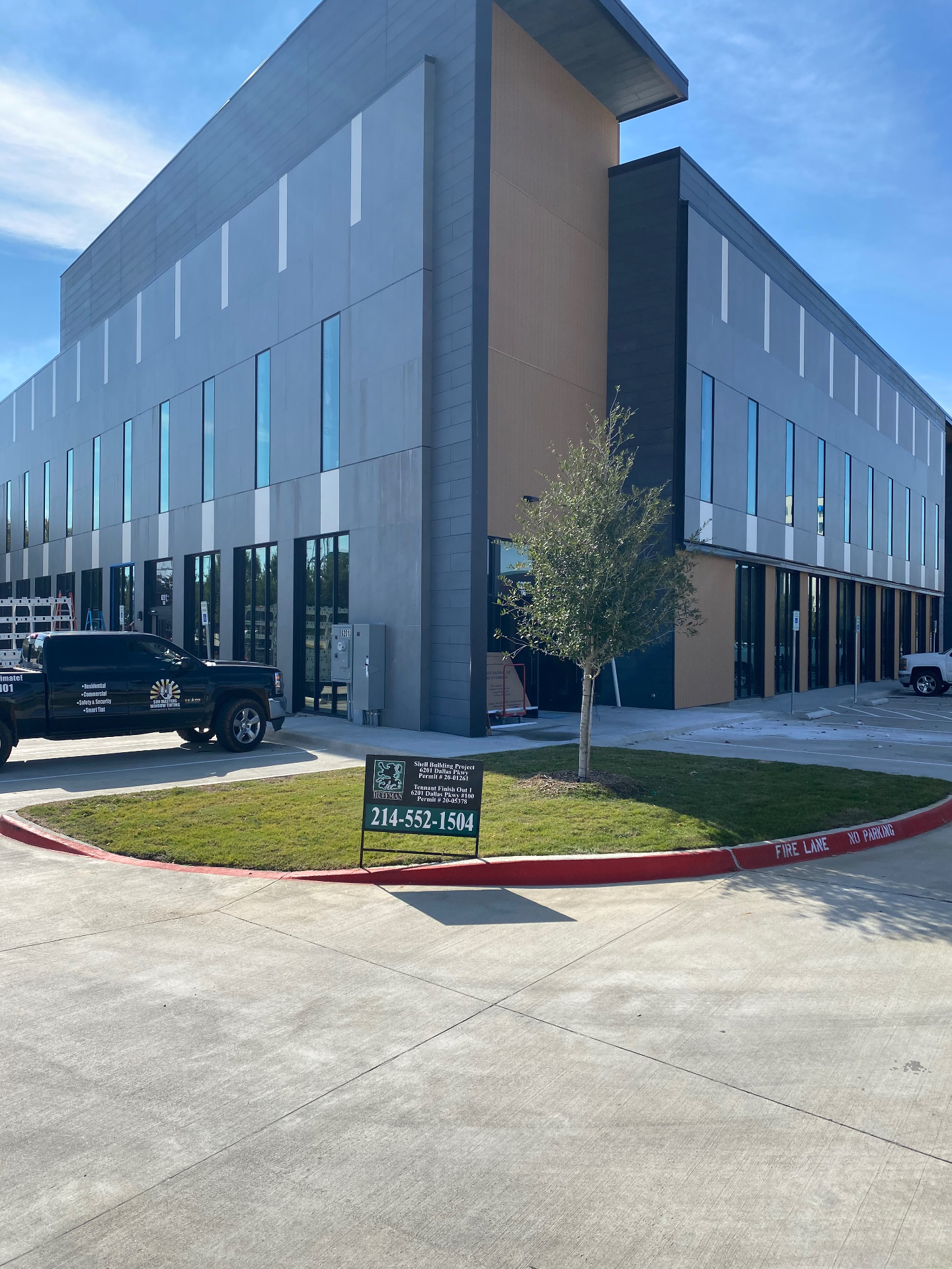 Modern grey office complex with reflective window film