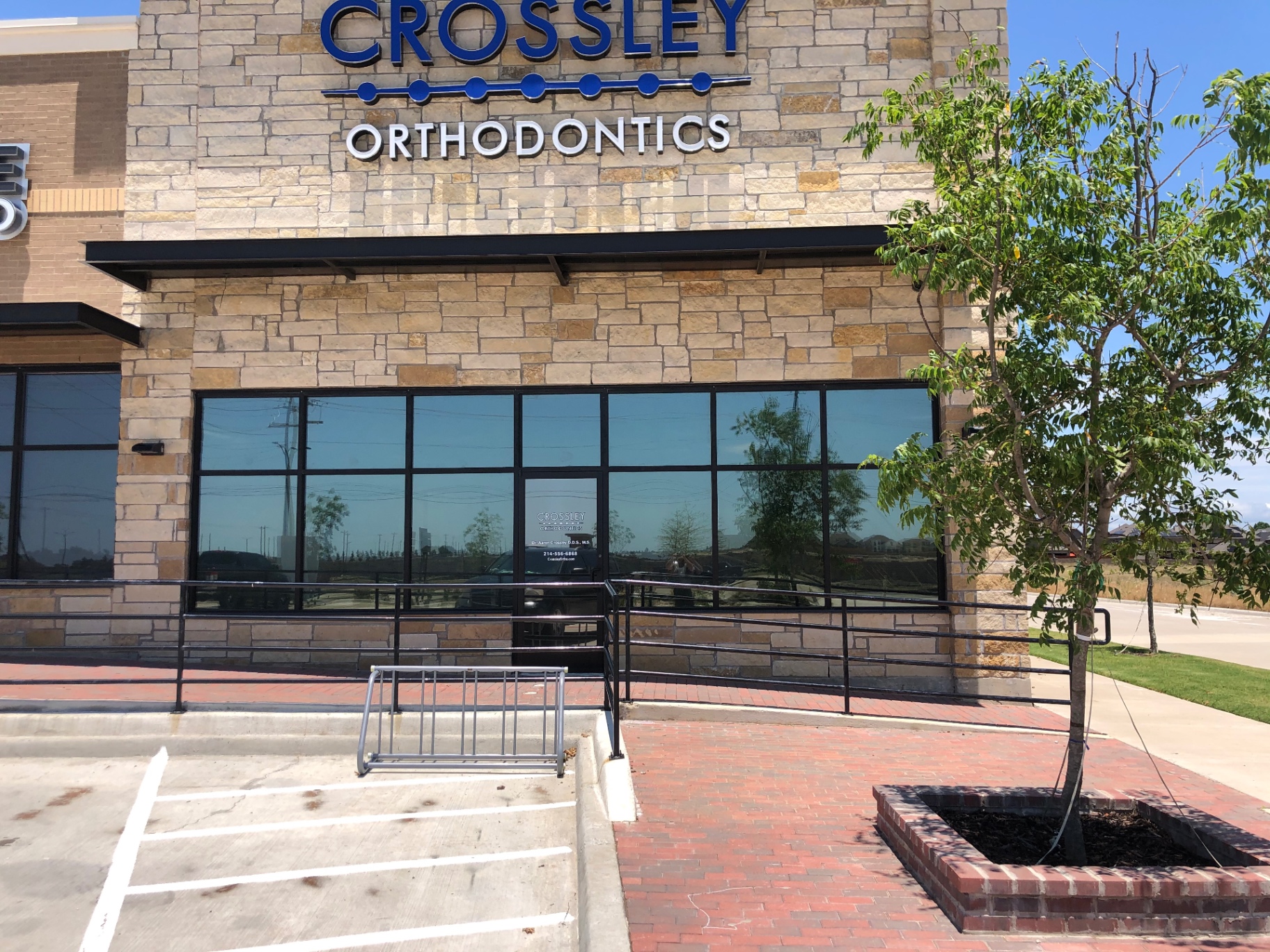 Crossley Orthodontics stone building with tinted storefront windows