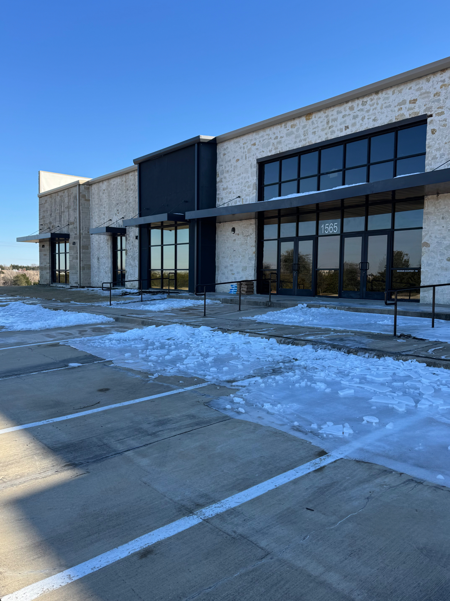 Commercial storefront with tinted windows and awnings in DFW
