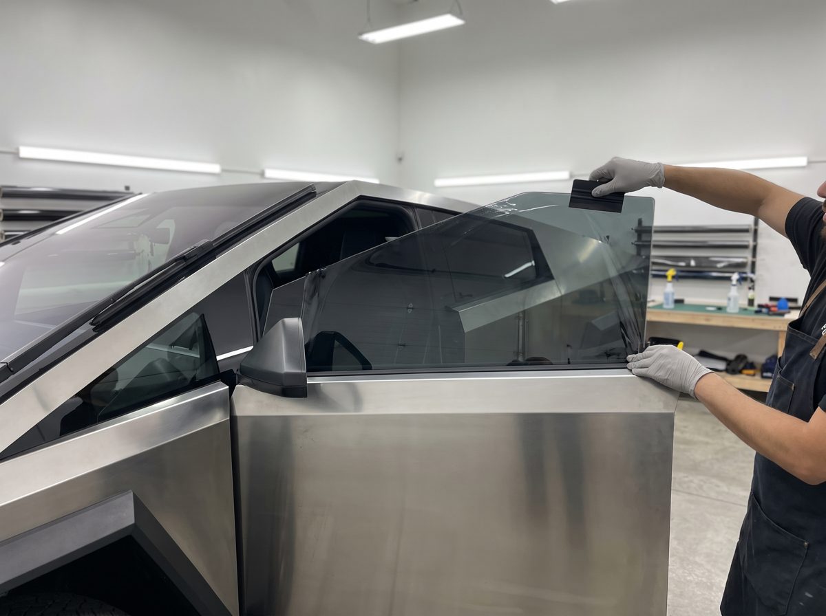 Window tint being installed on a Cybertruck