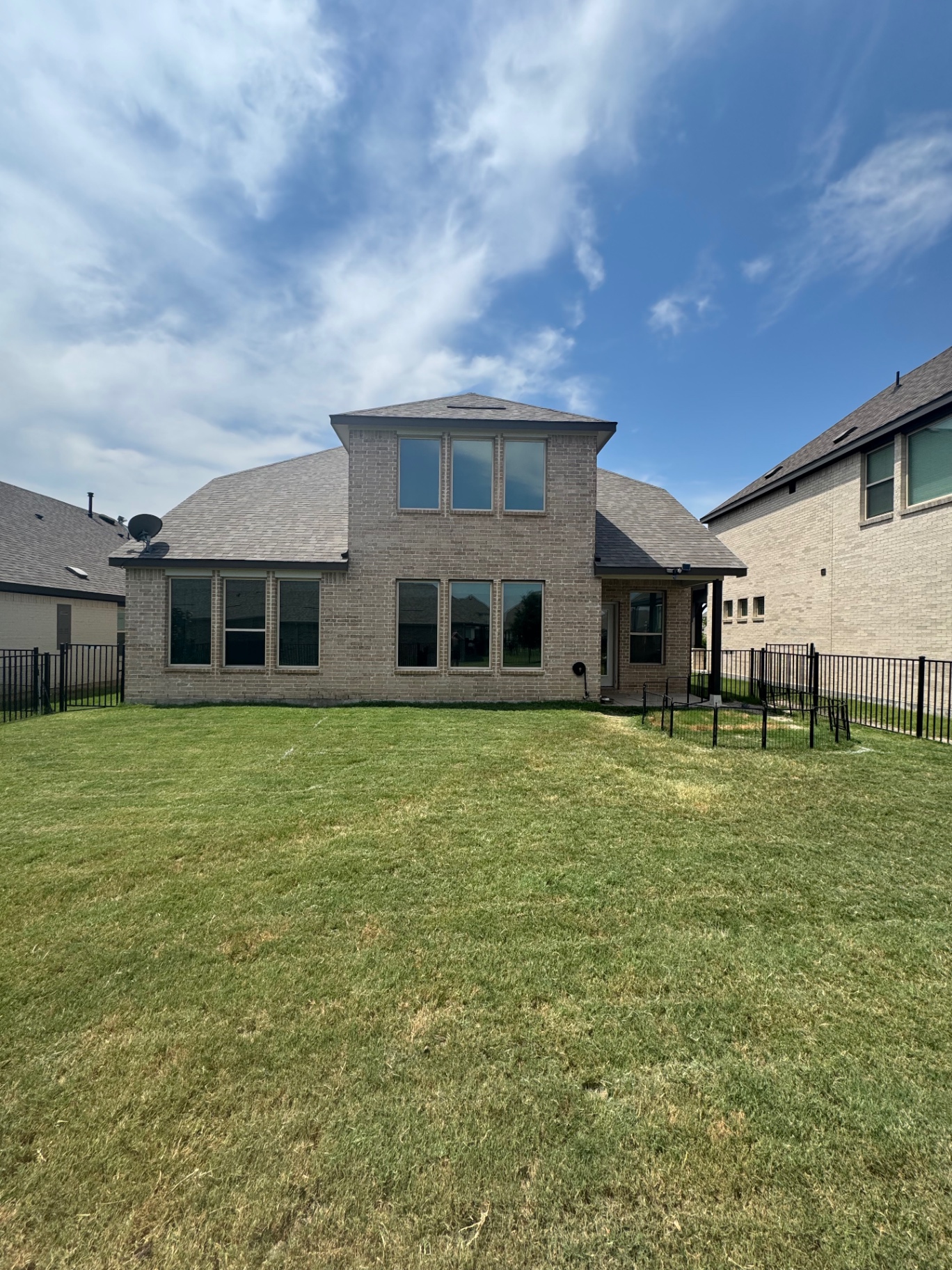 Brick home backyard view with tinted windows